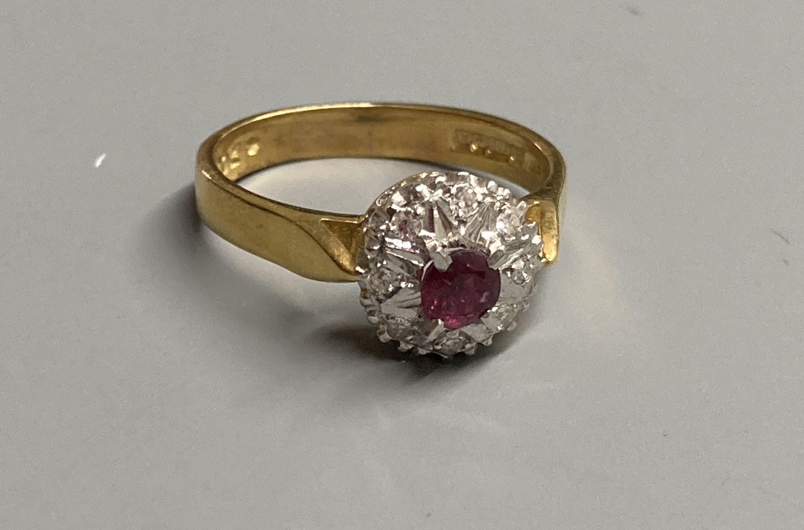 A modern 18ct gold, ruby and diamond chip set cluster ring, size M, gross 4.4 grams.